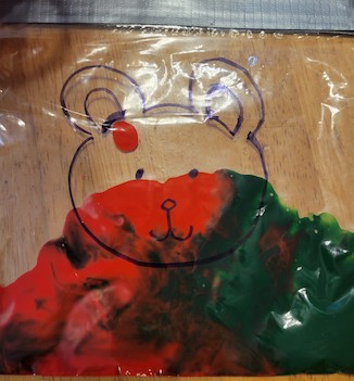 Red and green paint in a bag